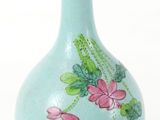 a blue vase with pink flowers painted on it