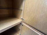 a close up of a wooden cabinet with two shelves