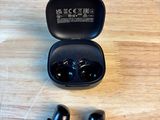 a close up of a pair of ear buds sitting on a table