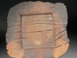 a stone plate that is sitting on a stand