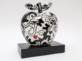 a black and white sculpture of an apple on a stand