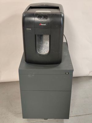 a close up of a paper shredder sitting on top of a box