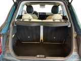 the back of a blue car with its trunk open and two seats down