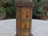 a small tin box sitting on a table in the garden