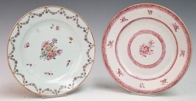 two plates with floral designs on them sitting side by side