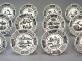 twelve black and white plates with a picture of people on them