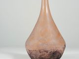 vase in the shape of a tear shaped bottle with a brown base