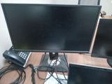 two computer monitors sitting on a desk next to each other