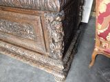 a wooden chest sitting next to a chair in a room