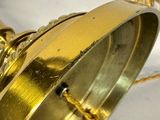 a gold clock with a chain around it on a table