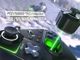 a close up of a video game controller with a green light on it