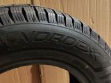 tire on the floor next to a box with a wooden box in the background