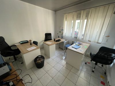 une pièce dans laquelle se trouvent deux bureaux et une chaise
