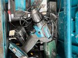 a blue tool box filled with power tools on the floor