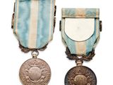 two medals and a medal on a white background