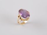 an oval amethorate ring with a yellow gold band