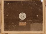 an old picture of a man in a suit and tie holding a coin