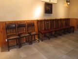 many wooden chairs lined up in a row in a room