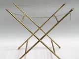 an image of a gold luggage rack with chains hanging from it