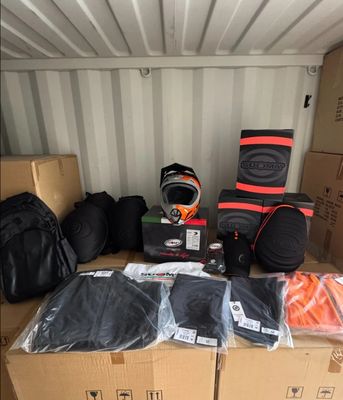 many bags of luggage sitting on top of a cardboard box