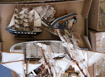 a lot of small model ships on display in a box
