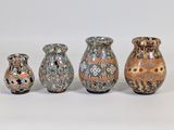 three vases are sitting next to each other on a white surface