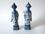 pair of blue and white porcelain figurines of a man and a woman