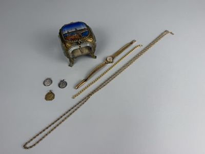 a gold bracelet, a ring, a watch, and a chain