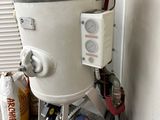 a red and white bucket sitting on top of a red and white machine