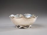 silver plated bowl on stand on grey background with light gray background
