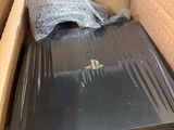 a box with a laptop inside of it on the floor