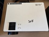 an image of a white projector sitting on top of a wooden table