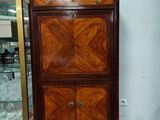 a cabinet that has a glass door on top of it
