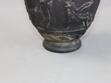 a black vase with a picture of a man and a woman on it
