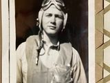 a black and white photo of a man in a pilot ' s uniform