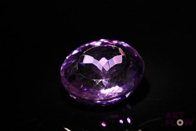 an image of a purple amethorate stone on a black surface