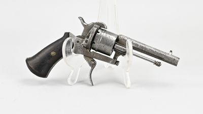 an old revolver with a wooden handle on a white background