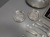 a table with silverware on it and a microwave in the background
