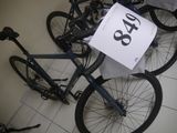 two bikes that are sitting on the floor with a price tag