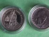 a close up of two coins in a plastic container on a green surface