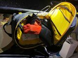 a yellow and black backpack sitting on the back of a car