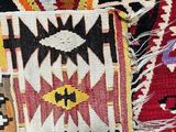 a close up view of a colorful rug with a pattern on it