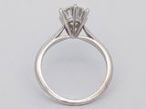 a close up of a diamond ring on a white background