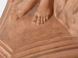 a statue of a woman with her feet on a pedestal