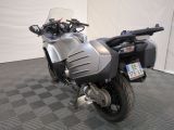 a motorcycle that is parked in a room with a checkered floor
