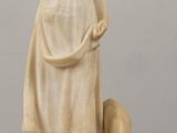 statue of a woman with a dog on a table