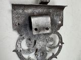 a metal hook that is attached to a wall