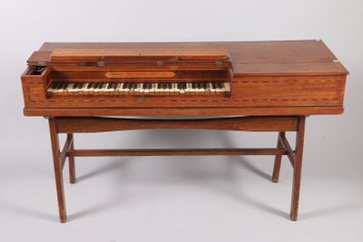 an old wooden piano with a keyboard on top of it