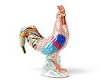 a figurine of a rooster on a white background