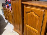 two wooden cabinets in the corner of a room